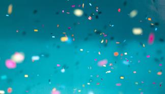multi-colored confetti on a teal background